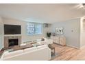 Cozy living room showcasing a fireplace, large window, and stylish decor, complemented by comfortable seating arrangements at 336 N Grant St # 412, Denver, CO 80203