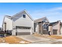 Charming home with gray siding, brick accents, and a two-car garage, enhanced by a red entry door at 6675 Fawn Path Ln, Castle Pines, CO 80108