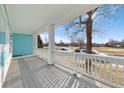 Covered front porch provides the perfect spot to relax while enjoying views of the neighborhood at 5129 Mt Arapaho Cir, Frederick, CO 80504