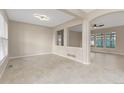 Bright and airy living room features neutral paint, tile flooring, and open layout with connecting rooms at 5129 Mt Arapaho Cir, Frederick, CO 80504