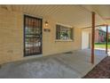 Close up of the front door to the home with security door and covered porch at 2236 S Osceola St, Denver, CO 80219