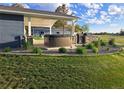 Backyard patio featuring a hot tub, outdoor kitchen area, and lush landscaping for relaxation and entertainment at 15945 Delta Ct, Brighton, CO 80603