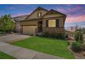 Charming home with a manicured lawn and stone accents on the facade with a two car garage and driveway at 3480 Mount Powell Dr, Broomfield, CO 80023