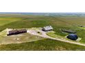Expansive aerial view of the property showcasing its well-kept structures and vast land at 46122 County Road 53, Bennett, CO 80102