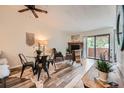 Cozy living room with a fireplace, dining area, and sliding door access to outdoor space for relaxation at 4285 S Salida Way # 17, Aurora, CO 80013