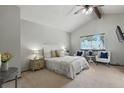 Serene main bedroom with vaulted ceilings, a cozy seating area, and a plush queen-sized bed at 3973 S Joplin Way, Aurora, CO 80013