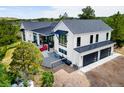 Modern farmhouse with black framed windows, dark metal awnings, a three-car garage and backyard at 922 W Wolfensberger Rd, Castle Rock, CO 80109