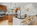 Well-lit kitchen featuring granite countertops, stainless steel appliances, and ample cabinet space, great for cooking at 9826 E 27Th Dr, Denver, CO 80238