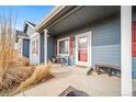 Covered front porch featuring red shutters, a sitting area, and a painted blue exterior at 253 E 8Th Ave, Byers, CO 80103