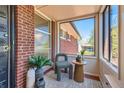 Charming sunroom featuring large windows and a cozy chair for relaxing and enjoying the view at 5975 S Milwaukee Way, Centennial, CO 80121
