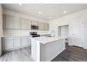 Bright kitchen with a large center island, stainless appliances and light cabinetry at 19079 E 94Th Pl, Commerce City, CO 80022