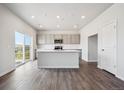 Well-lit kitchen with stainless appliances and light gray cabinetry at 19079 E 94Th Pl, Commerce City, CO 80022