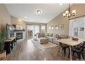 Open-concept living room features a fireplace, hardwood floors, and modern furniture at 1079 Parkline Ln, Monument, CO 80132