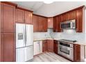 The renovated kitchen features stainless steel appliances, granite countertops and wooden cabinets at 720 16Th St # 207, Denver, CO 80202
