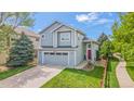 Inviting two-story house featuring a well-kept lawn, two-car garage and appealing architectural details at 6650 Stagecoach Ave, Firestone, CO 80504