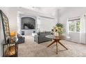 Spacious living room with a large window, plush carpeting and comfortable seating, perfect for relaxing at 6650 Stagecoach Ave, Firestone, CO 80504