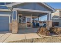 Inviting front porch with brick accents, a cozy seating area, and a welcoming entrance at 1489 N Monument Dr, Castle Rock, CO 80104