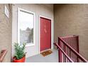 Inviting entrance with a red door, modern accents, and a well-maintained walkway at 5300 E Cherry Creek South Dr # 324, Denver, CO 80246