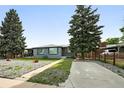 Charming single-story home with a gray exterior, well-maintained lawn, and mature landscaping at 475 S Eliot St, Denver, CO 80219