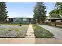 Charming single-story home with a gray exterior, well-maintained lawn, and mature landscaping at 475 S Eliot St, Denver, CO 80219