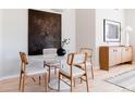 Modern dining area with round white table, stylish chairs, and elegant decor at 1440 Little Raven St # 107, Denver, CO 80202