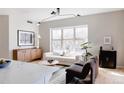 Bright living room featuring large windows, modern lighting, sleek furniture, and hardwood floors at 1440 Little Raven St # 107, Denver, CO 80202