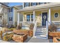 Lovely home with inviting entrance, a cozy porch, and charming planter box landscaping at 9113 E 36Th Ave, Denver, CO 80238