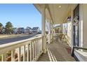 Inviting front porch with columns, swing and chairs, offering a relaxing outdoor space at 9113 E 36Th Ave, Denver, CO 80238