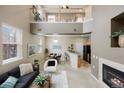 Spacious living room with a fireplace, complemented by a dining area and an open-concept kitchen at 6702 S Winnipeg Cir # 101, Aurora, CO 80016