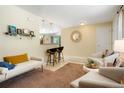 Cozy living room showcases tile floors, a breakfast bar, and comfortable seating arrangement at 2964 S Akron St, Denver, CO 80231