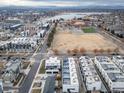 Community aerial view with modern homes, a park, and a lake in the background at 1810 Julian St # 105, Denver, CO 80204