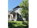 Charming home with a well-maintained lawn, red front door, and classic architectural details at 2283 S Bannock St, Denver, CO 80223