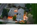 Aerial view of home showcasing a three car garage, patio, and outdoor fireplace at 18 Club Ln, Littleton, CO 80123
