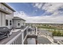 Relaxing deck area, showcasing outdoor seating, a grill, and scenic views of the surrounding landscape at 8625 E 125Th Ct, Thornton, CO 80602