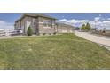 Manicured lawn, stone accents, and a pristine driveway enhance this property's curb appeal at 8625 E 125Th Ct, Thornton, CO 80602