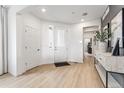 Bright entryway featuring wood floors, white trim, and a view into the house at 3381 N Denali St, Aurora, CO 80019