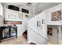 Bright foyer featuring a staircase, tile flooring, and decorative artwork at 10991 Expedition, Littleton, CO 80125