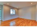 Bright bedroom with natural light, hardwood flooring, and neutral color palette at 6812 Blue Jay Dr, Parker, CO 80138