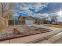 Single Gathering home with a well-manicured lawn and attached two-car garage at 6812 Blue Jay Dr, Parker, CO 80138