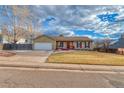 Charming single-Gathering home with a well-manicured lawn and attached two-car garage at 6812 Blue Jay Dr, Parker, CO 80138