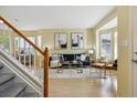 Cozy living room with large windows, light hardwood floors, and stylish modern decor at 15597 E Dorado Ave, Centennial, CO 80015