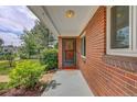 Covered front porch area featuring a secure front door and well-maintained landscaping at 1541 Poplar St, Denver, CO 80220