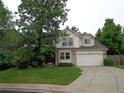 Attractive two-story home with a two-car garage, lush front lawn, and a mature tree for shade at 13651 Silverton Dr, Broomfield, CO 80020