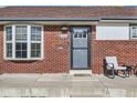 Close up of the front door with chairs outside and well maintained facade at 7120 Galapago St, Denver, CO 80221