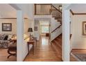 Elegant foyer with hardwood floors, staircase, and views into the living room and office areas at 10032 Astoria Ct, Lone Tree, CO 80124