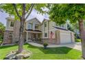 Charming two-story home with brick accents, a two-car garage, and a well-maintained front lawn and walkway at 10032 Astoria Ct, Lone Tree, CO 80124