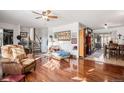 Inviting living room with gleaming hardwood floors and open access to dining area and staircase at 860 S 7Th Ave, Brighton, CO 80601