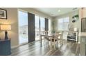 Dining area with a wooden table and chairs, bright windows, and sliding glass doors at 3734 Makley Cir, Castle Rock, CO 80104