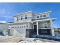 Two-story house with gray siding, stone accents, and a two-car garage at 3734 Makley Cir, Castle Rock, CO 80104