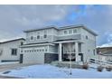 Two-story house with gray siding, stone accents, and a two-car garage at 3734 Makley Cir, Castle Rock, CO 80104